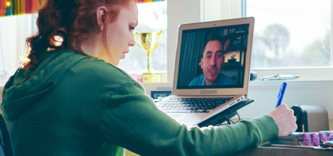 High school student attending an online class with her laptop at home