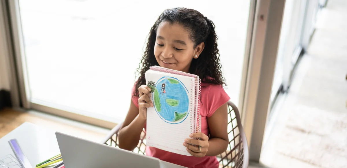 little girl with notebook in her hands