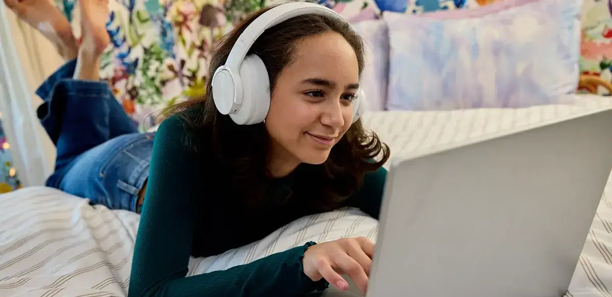 girl using her computer and headphones